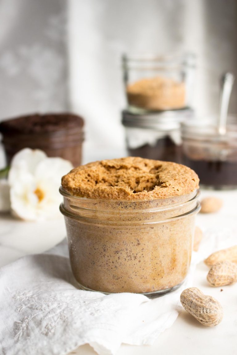 peanut butter mug cake in a small mason jar with peanuts