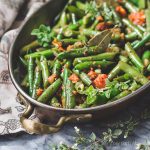 Mexican green beans with tomatoes, oregano and bay leaf.