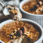 hazelnut creme brulee with crackly top and hazelnuts in a ramekin.