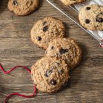 Keto chocolate chip cookies on a table with red twine.