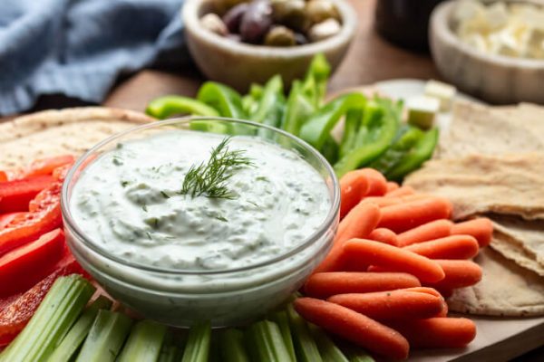 Greek tzatziki cucumber yogurt sauce with cut veggies.
