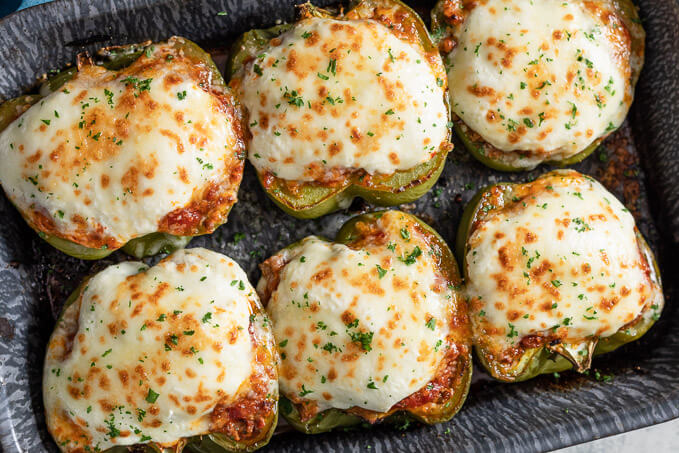 top-down-view of keto lasagna stuffed peppers in a pan